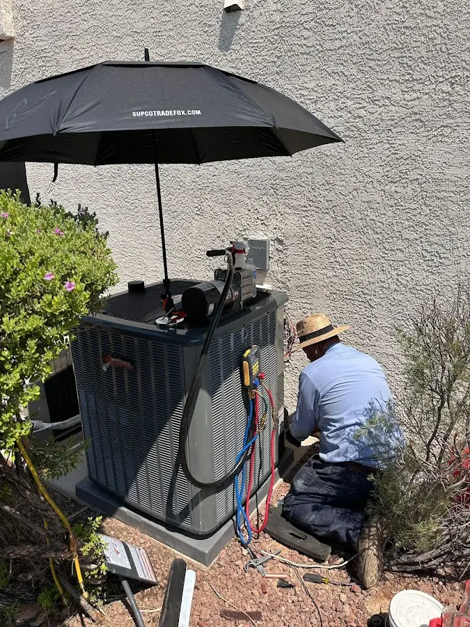 HVAC technician performing outdoor AC maintenance in Fernley